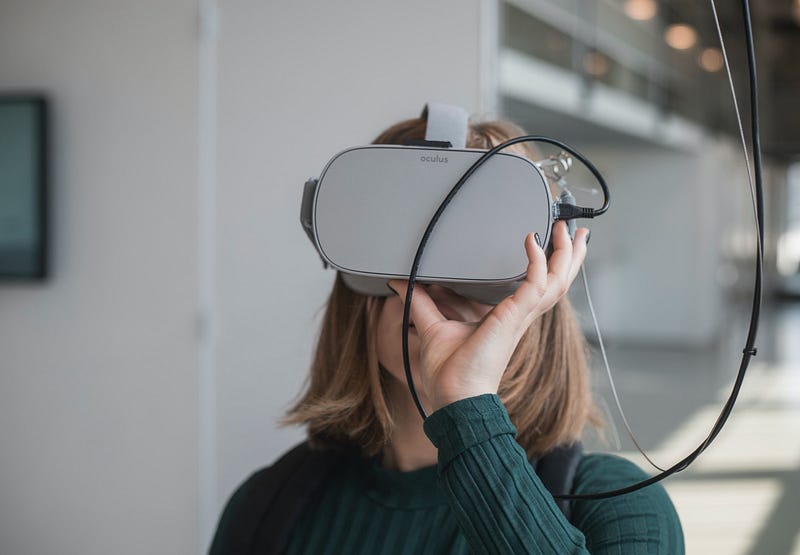 A woman with a VR headset enjoying virtual reality